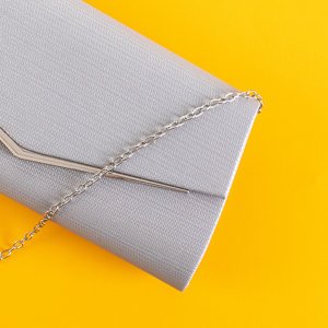 Silver shimmering clutch bag on a chain - Handbags